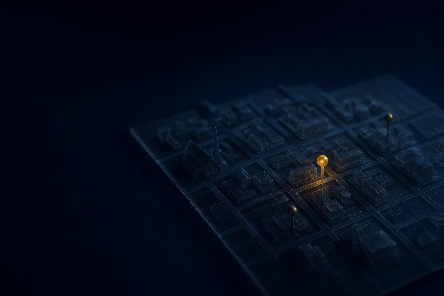 A dark glass model of town streets with three brass map pins, one glowing gold