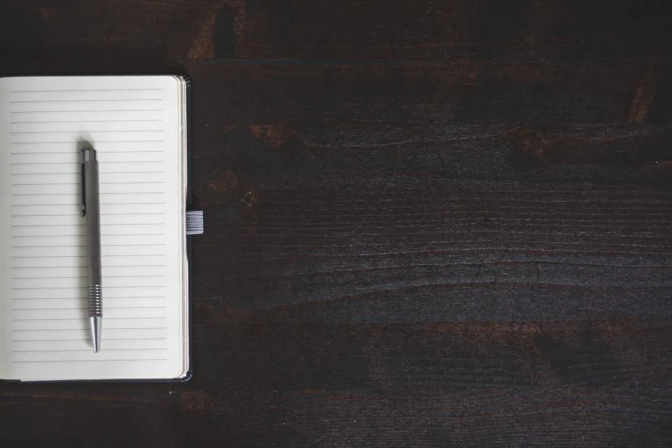 Notebook and pen used to plan a law firm Google Business Profile